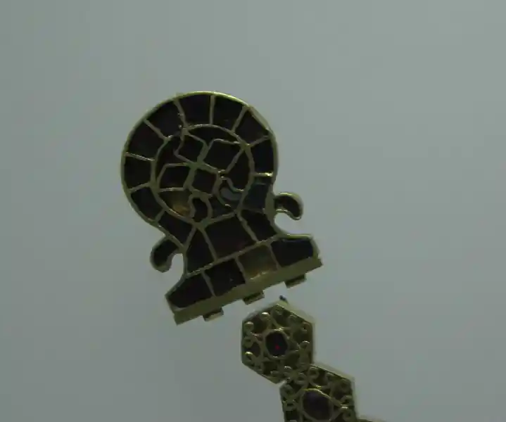 A cross at one end of a gold necklace, decorated with red stones